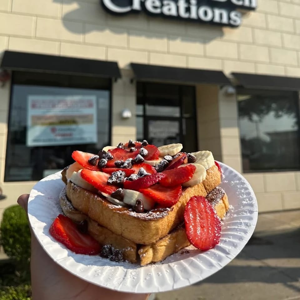 French toast topped with strawberries, bananas, chocolate chips, and powdered sugar from Bagel & Deli Creations.