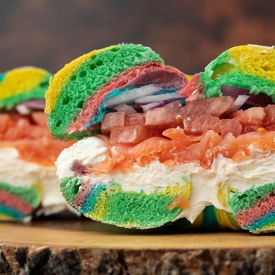 A rainbow bagel from Bagel & Deli Creations, filled with cream cheese, lox, and red onions.